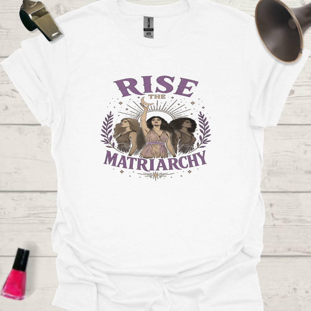 White t-shirt with 'Rise the Matriarchy' graphic design on a wooden surface.